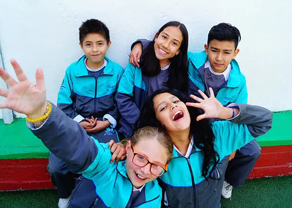niños y niñas conviviendo con alegría en su escuela de Izcalli, reflejando integración y confianza en el aula
